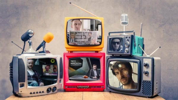 Retro old TV set receivers and microphones on table front textur
